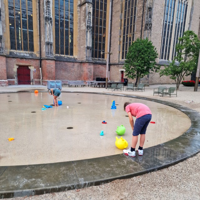 Naast de Lebuïnuskerk in Deventer is een fontein met stoelen er omheen. Onze kinderen konden er spelen met waterspeelgoed uit een grote bak.